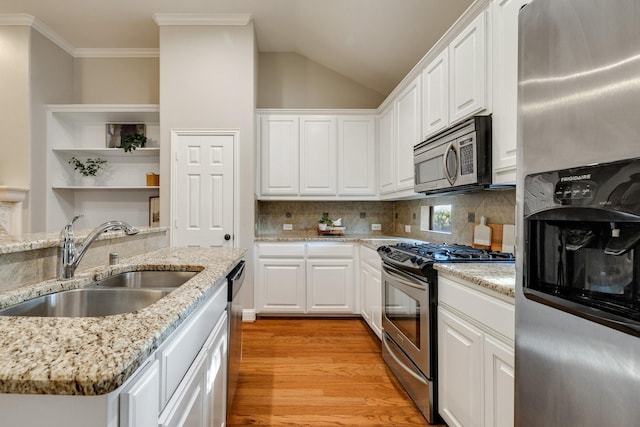 kitchen with light wood-type flooring, stainless steel appliances, white cabinetry, and sink