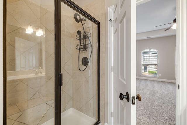 full bath featuring a ceiling fan, a shower stall, and baseboards