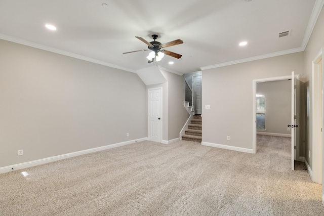 interior space featuring light carpet, ceiling fan, and ornamental molding