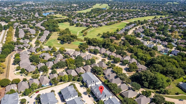 bird's eye view with golf course view, a water view, and a residential view