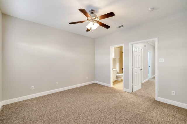 empty room with ceiling fan and light carpet