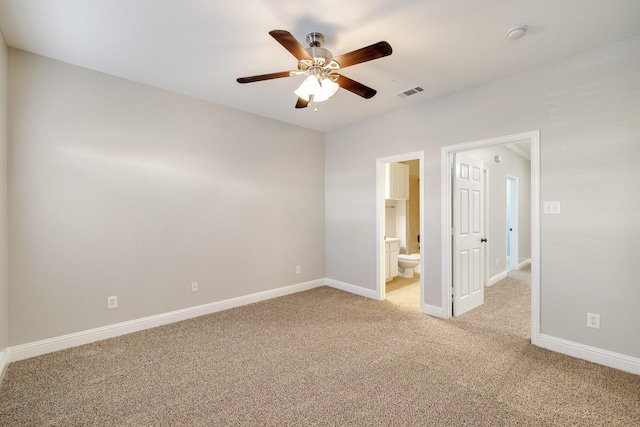 unfurnished bedroom with ceiling fan, connected bathroom, light carpet, visible vents, and baseboards