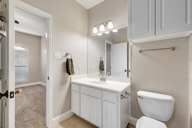 bathroom with tile patterned floors, vanity, and toilet