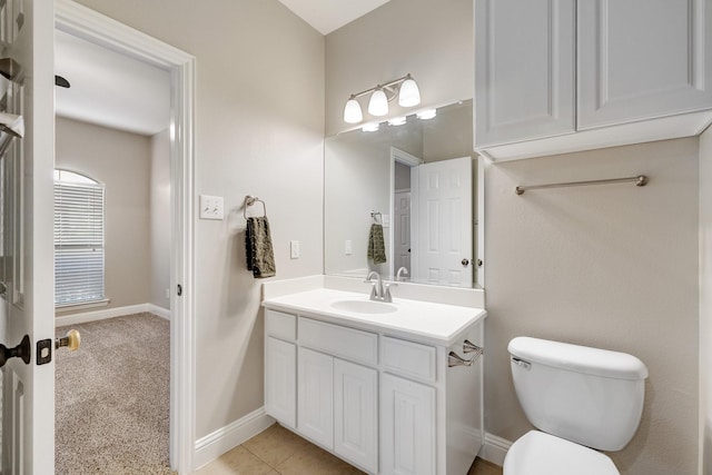 bathroom featuring tile patterned flooring, baseboards, vanity, and toilet