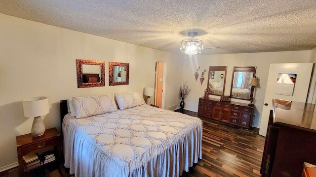 bedroom featuring a textured ceiling, dark hardwood / wood-style floors, and ceiling fan with notable chandelier