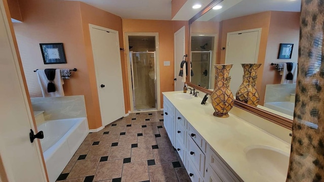 bathroom with vanity and separate shower and tub