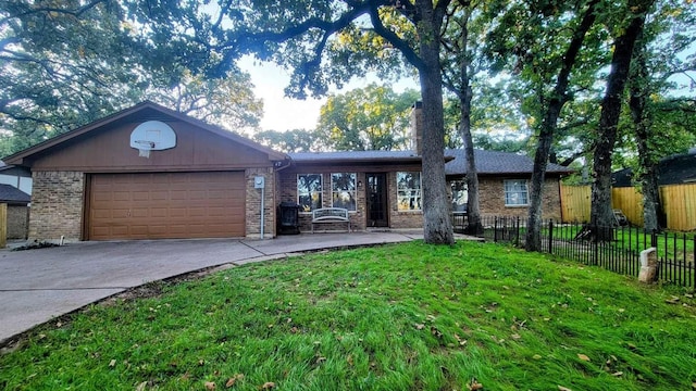 ranch-style home with a garage and a front lawn