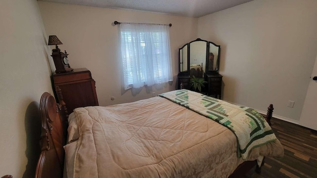 bedroom featuring dark wood-type flooring