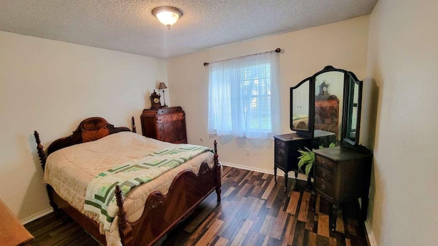 bedroom featuring a textured ceiling and dark hardwood / wood-style flooring