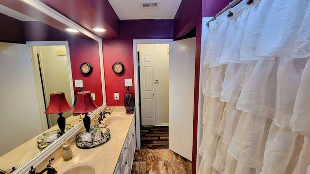 bathroom with vanity and a textured ceiling