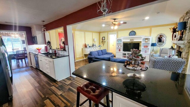 kitchen featuring decorative light fixtures, dark hardwood / wood-style floors, white cabinetry, and ceiling fan