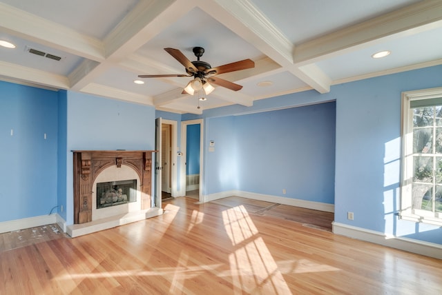 unfurnished living room featuring beamed ceiling, a premium fireplace, and coffered ceiling