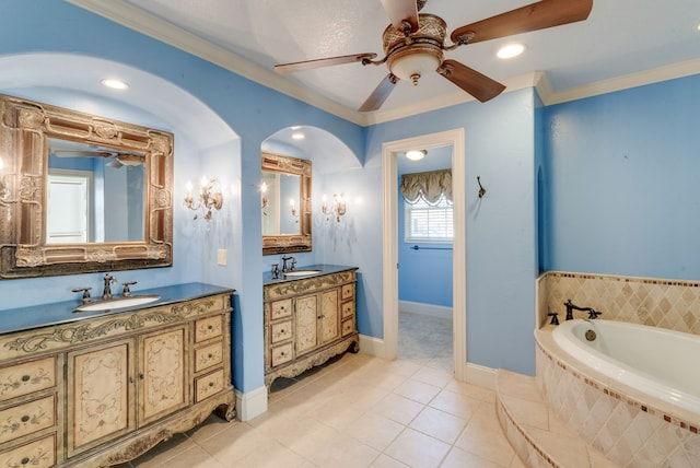 bathroom with ornamental molding, a relaxing tiled tub, tile patterned floors, and vanity