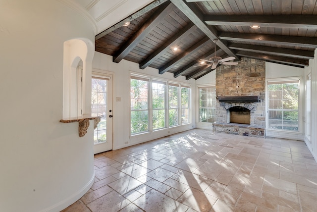 unfurnished living room with lofted ceiling with beams, ceiling fan, a stone fireplace, and wood ceiling