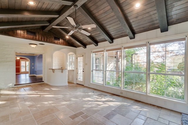 unfurnished sunroom featuring lofted ceiling with beams, ceiling fan, and wood ceiling