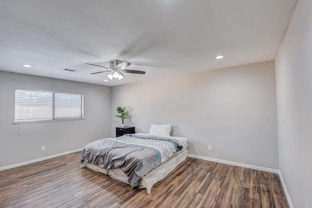 bedroom featuring hardwood / wood-style flooring and ceiling fan