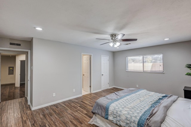 bedroom with ceiling fan and dark wood-type flooring