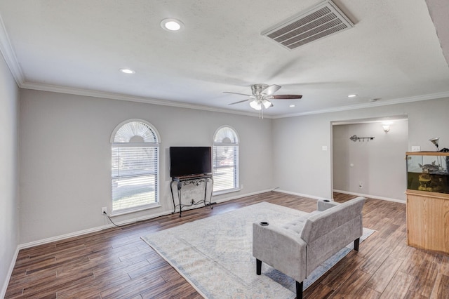 living room with ceiling fan and ornamental molding