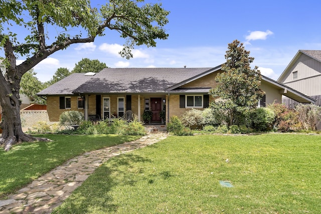 ranch-style home with a front lawn