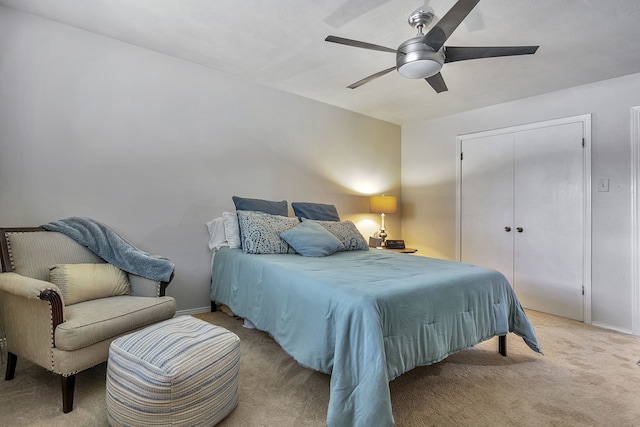 carpeted bedroom with ceiling fan and a closet