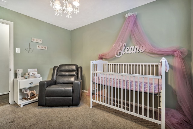 carpeted bedroom with an inviting chandelier and a nursery area