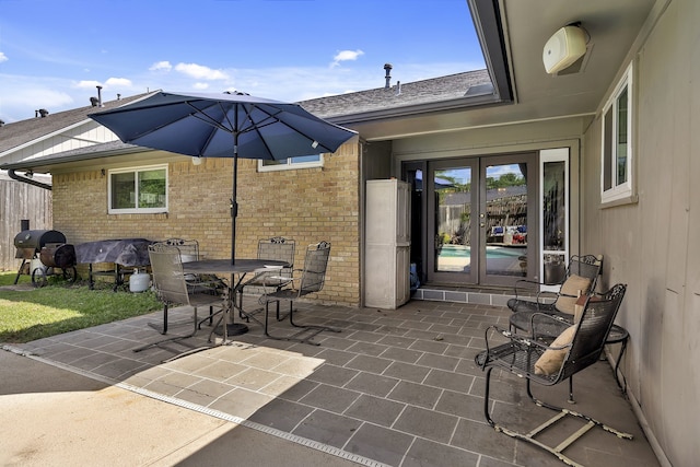 view of patio / terrace featuring a grill and french doors