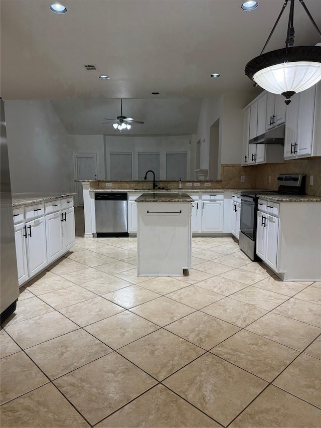 kitchen with a kitchen island, appliances with stainless steel finishes, white cabinets, hanging light fixtures, and kitchen peninsula