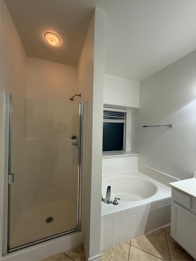 bathroom with vanity, tile patterned floors, and plus walk in shower