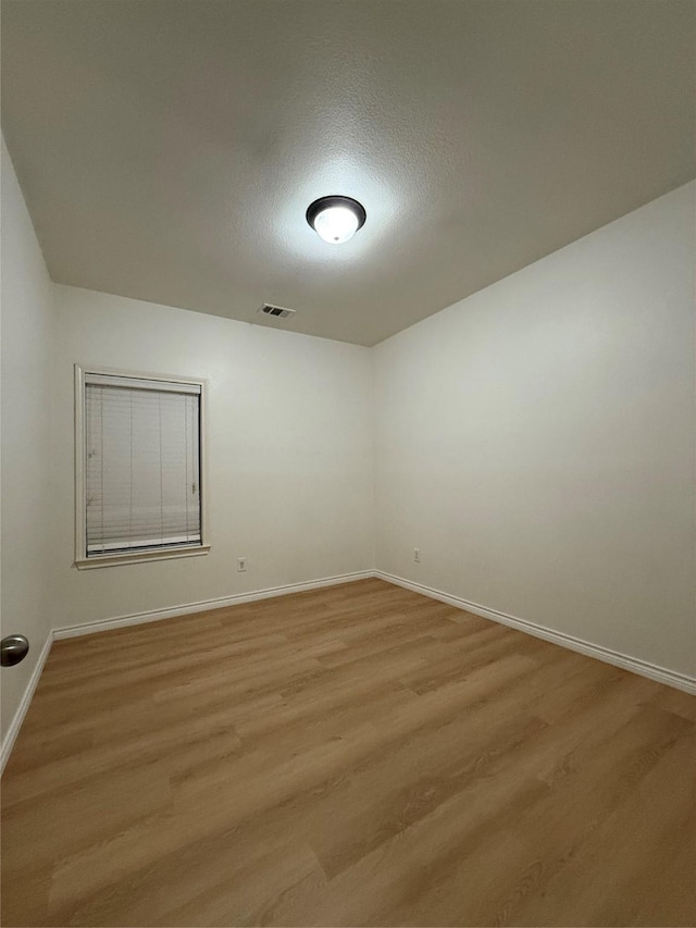 empty room with light hardwood / wood-style floors