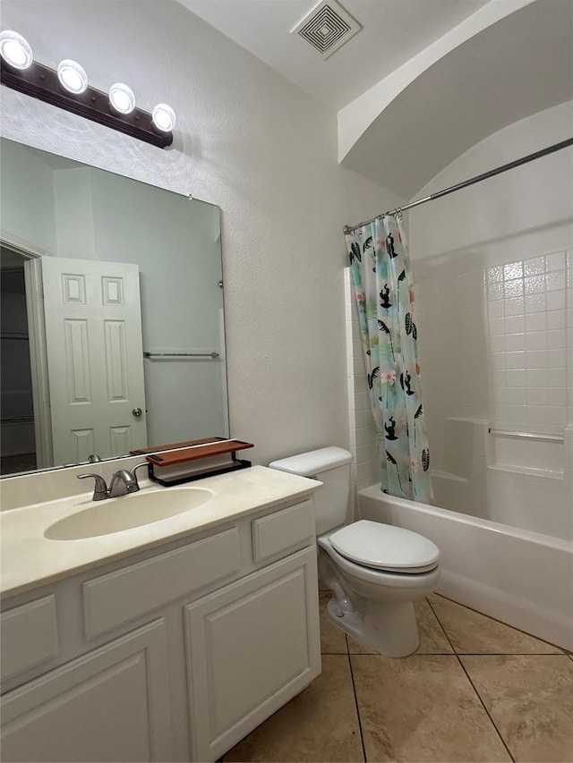 full bathroom featuring tile patterned flooring, vanity, toilet, and shower / bath combo with shower curtain