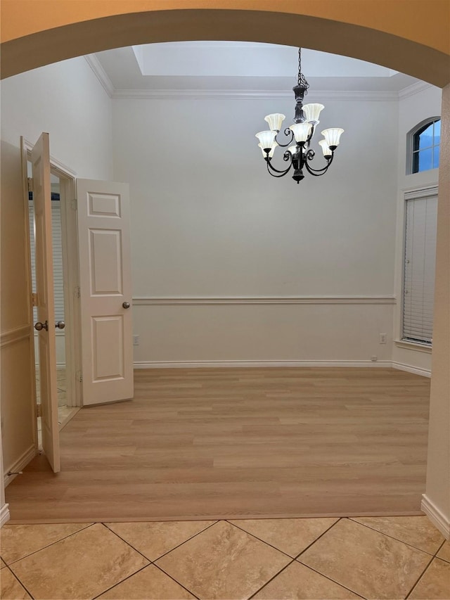 interior space with light hardwood / wood-style floors, ornamental molding, and a chandelier