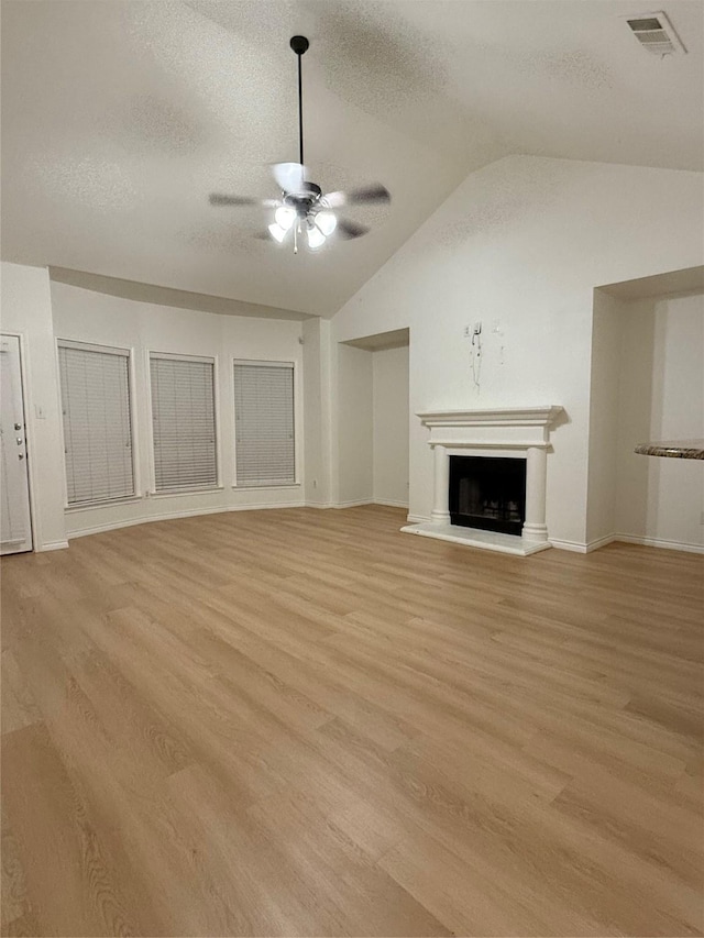 unfurnished living room with a textured ceiling, ceiling fan, and light hardwood / wood-style flooring