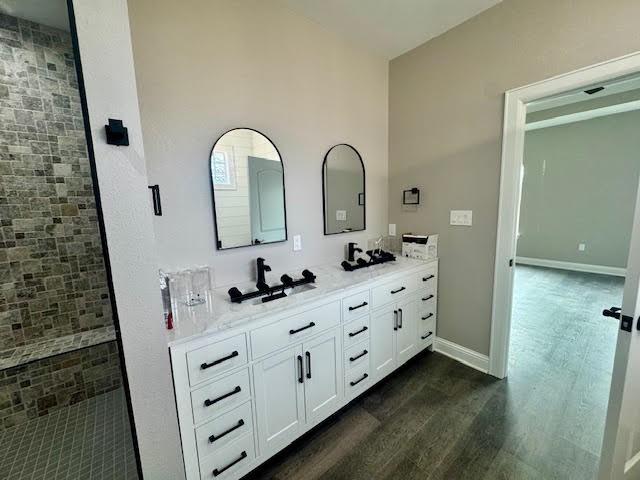 bathroom with vanity, wood-type flooring, and walk in shower