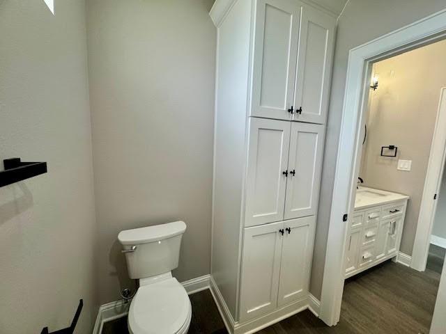 bathroom featuring hardwood / wood-style flooring, vanity, and toilet