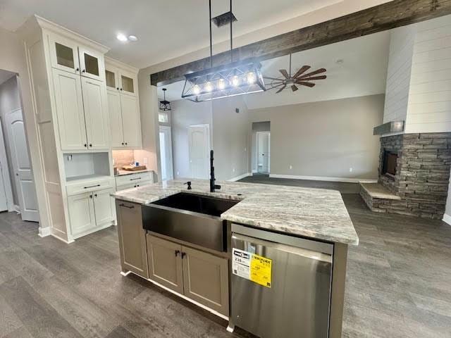 kitchen featuring a fireplace, ceiling fan, decorative light fixtures, dishwasher, and white cabinetry