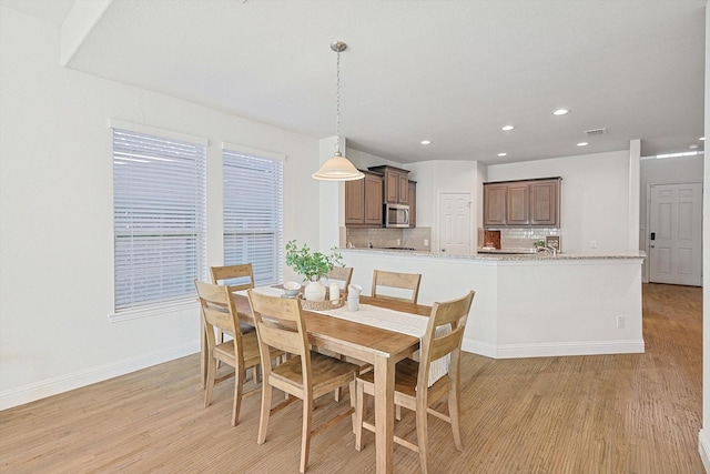 dining space featuring light wood-type flooring, visible vents, baseboards, and recessed lighting