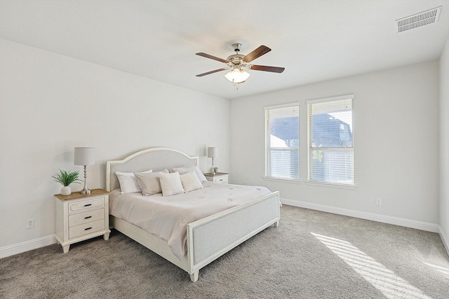 carpeted bedroom featuring baseboards, visible vents, and a ceiling fan