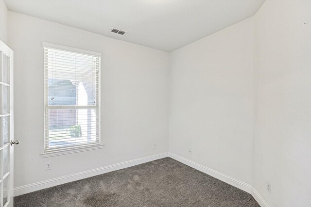 carpeted spare room with french doors