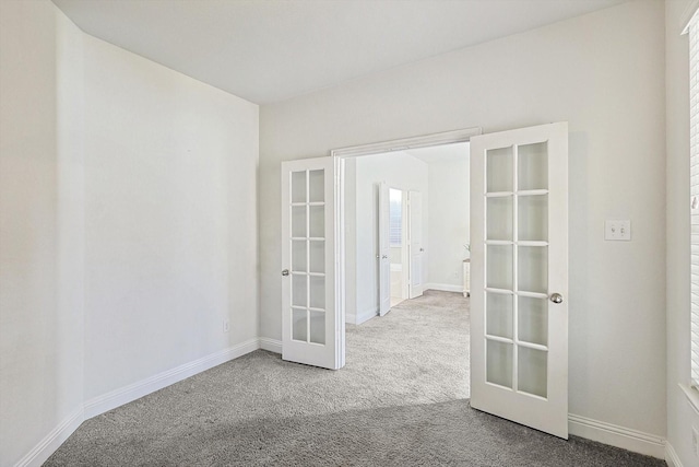 unfurnished room featuring carpet floors, french doors, and baseboards