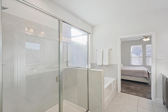 bathroom with a stall shower, connected bathroom, tile patterned floors, a garden tub, and vanity