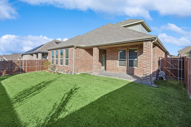 rear view of property featuring a lawn and a patio