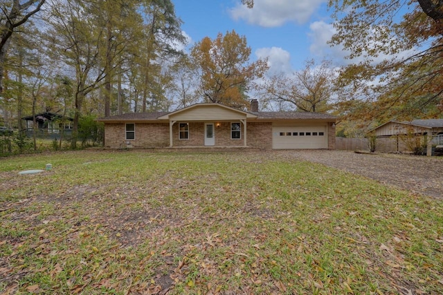 single story home featuring a garage and a front lawn