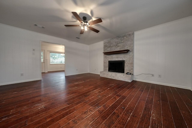 unfurnished living room featuring ceiling fan, dark wood-type flooring, and a brick fireplace