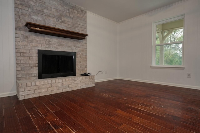 unfurnished living room featuring a fireplace, crown molding, and dark wood-type flooring