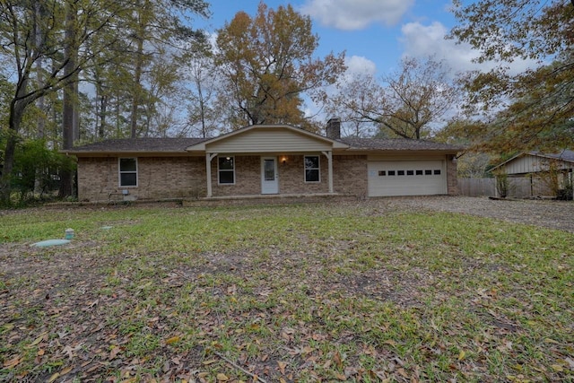 ranch-style house featuring a front yard and a garage