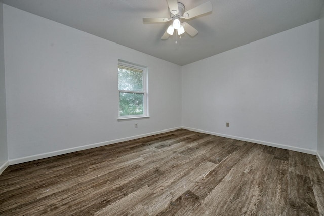 empty room featuring ceiling fan and dark wood-type flooring