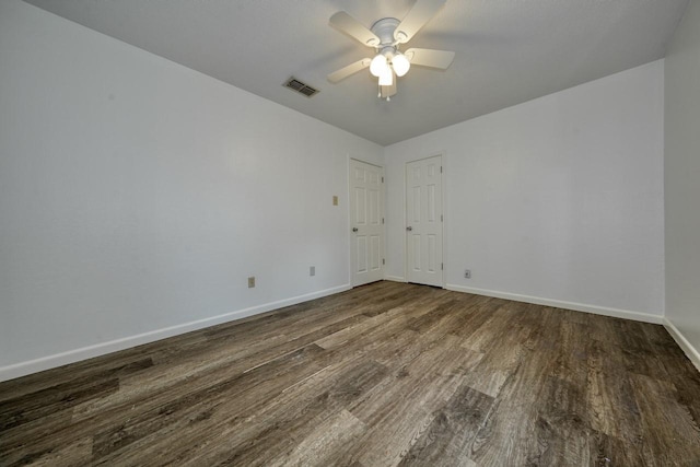 empty room featuring ceiling fan and dark hardwood / wood-style flooring