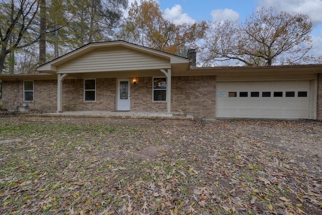 ranch-style home with a porch and a garage