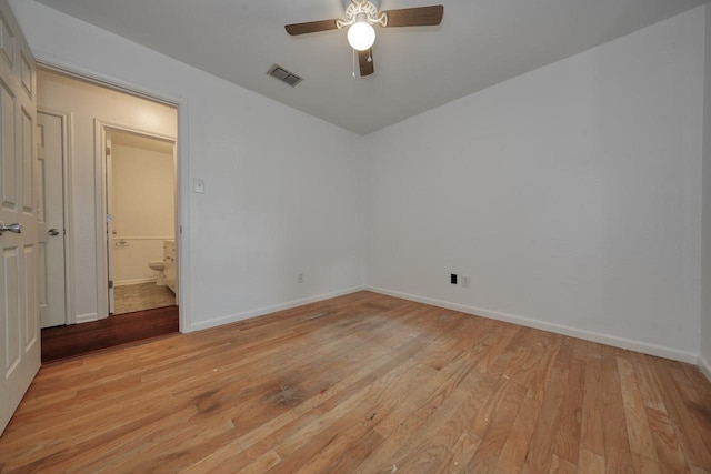 spare room with ceiling fan and light wood-type flooring