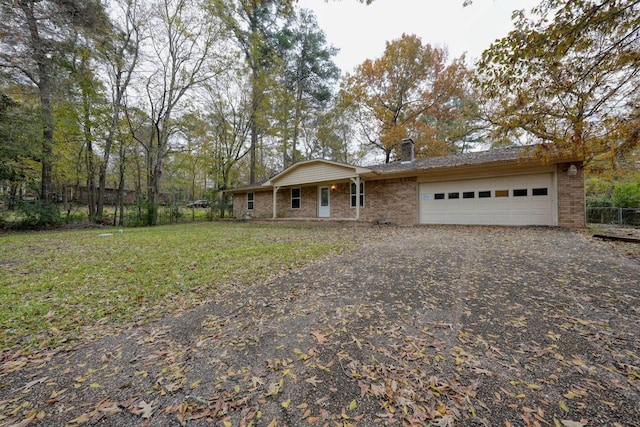 single story home with a garage and a front lawn